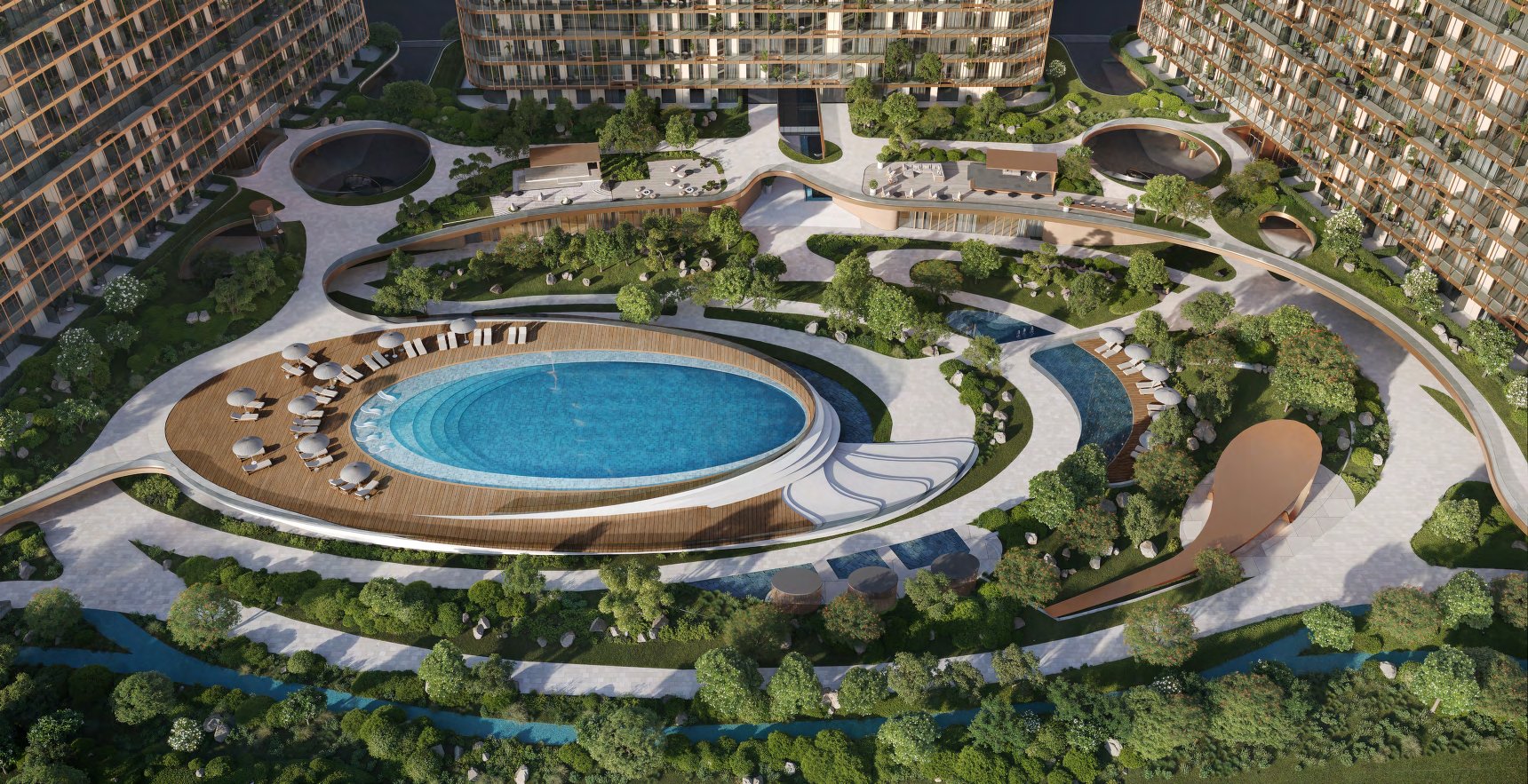 Aerial view of HADO's oval pool and gardens between three towers