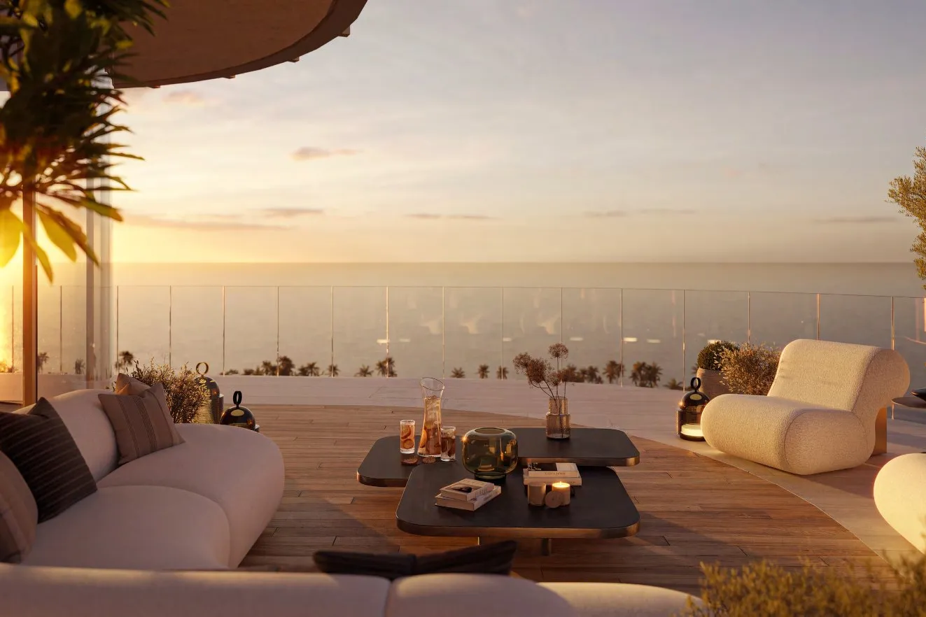 Private terrace with soft seating overlooking the sea at sunset