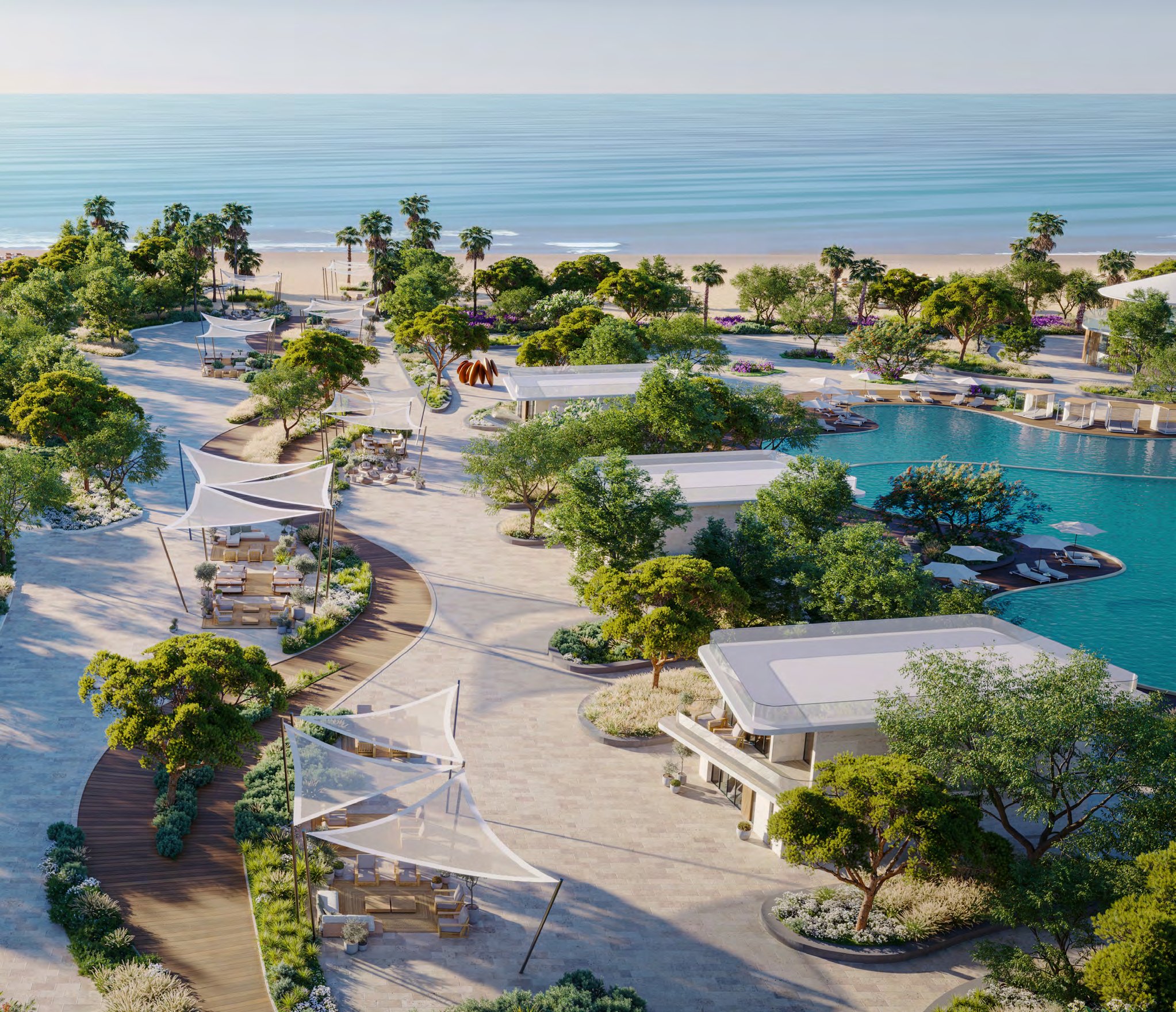 Aerial of Siora's beachfront gardens, shaded walkways and pool by the sea